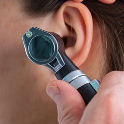 Close up photo of an ear examination with an otoscope