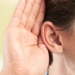 Photo of an hand cupped behind someone's ear